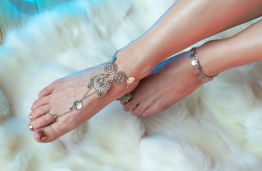 pexels-photo-7067962-7067962 High angle anonymous female legs with stylish pedicure wearing oriental silver anklets above fluffy carpet